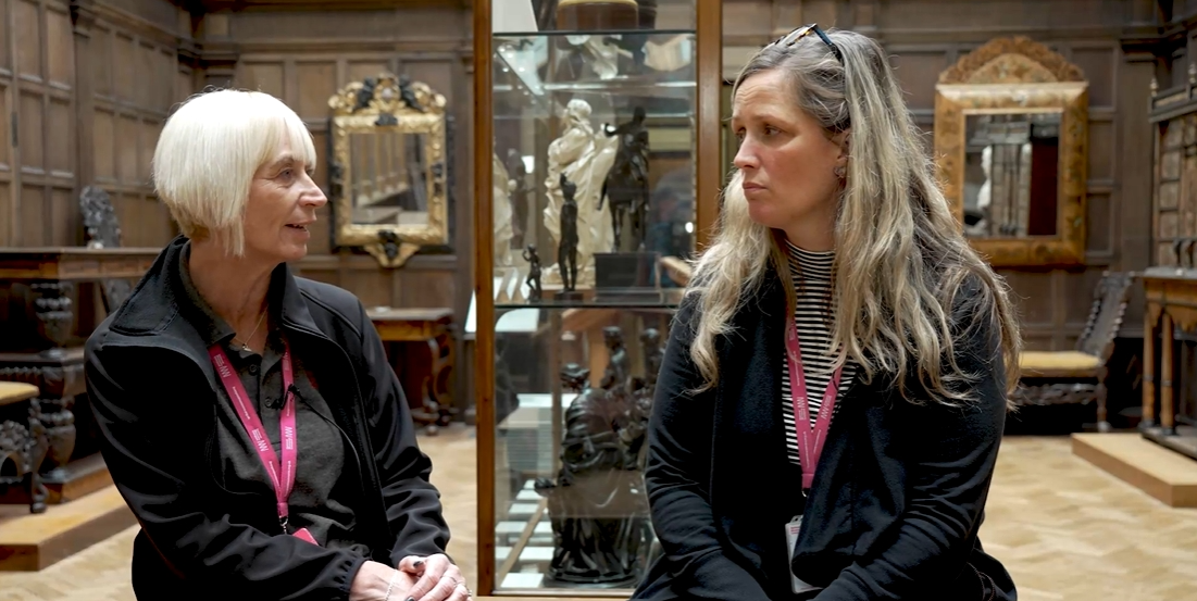Two people talking in a museum